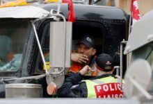 A trucker speaks with a police officer-Milenio Stadium-Canada