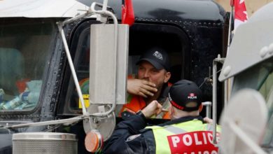 A trucker speaks with a police officer-Milenio Stadium-Canada