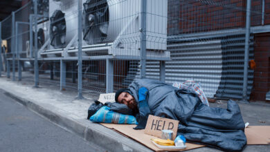 dirty-homeless-with-help-sign-lies-on-city-street-2021-08-27-09-42-48-utc - milenio stadium