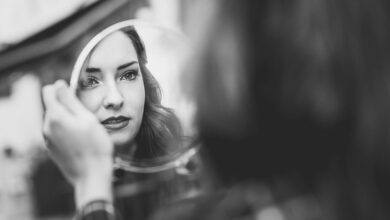 young-woman-looking-at-herself-in-a-little-mirror-2021-08-26-19-59-33-utc
