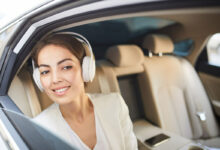 smiling-woman-listening-to-music-in-car-2021-09-24-03-57-54-utc