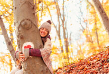 Woman hugging a tree in forest
