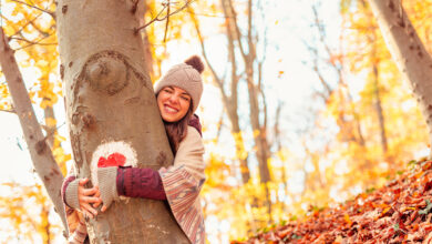 Woman hugging a tree in forest