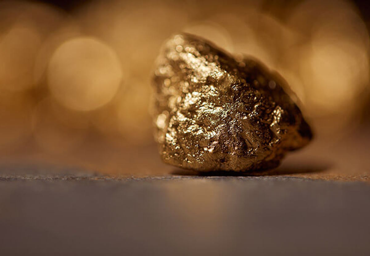 selective-focus-of-golden-stone-on-grey-marble-and-2023-11-27-04-53-15-utc
